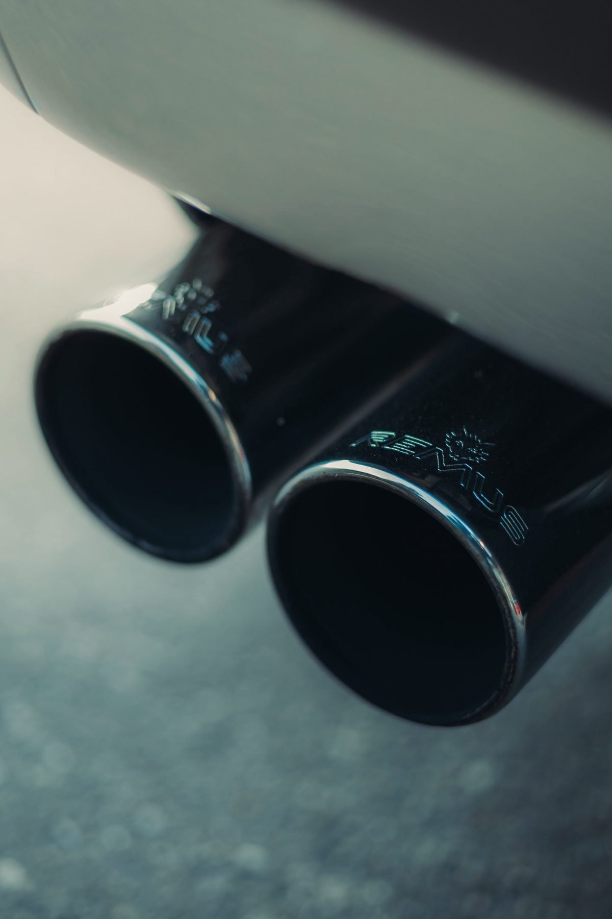 A pair of dark exhaust tips on the rear of a vehicle.