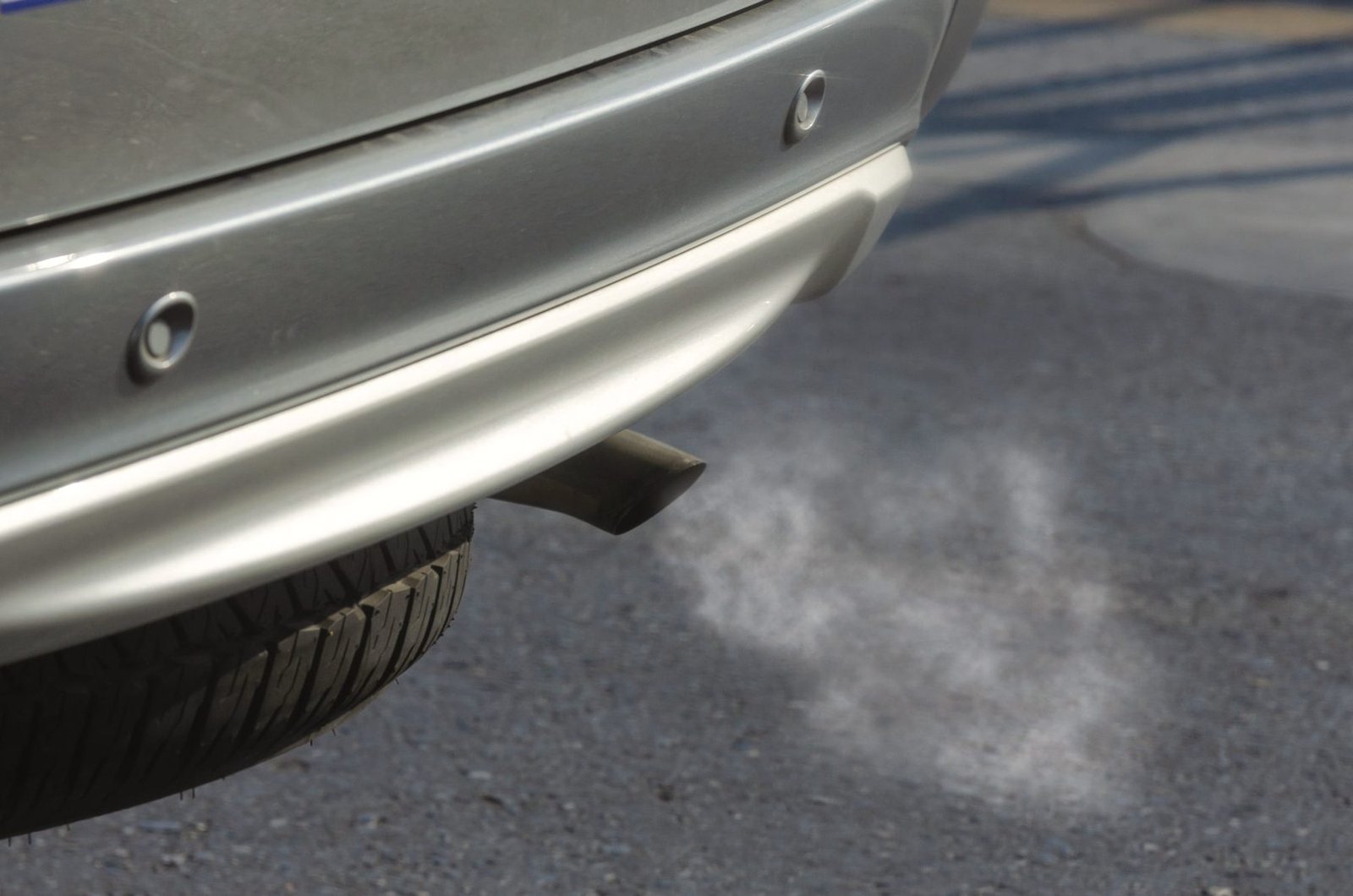Condensation drifting from a tailpipe on a cold morning.